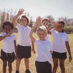 School children waving